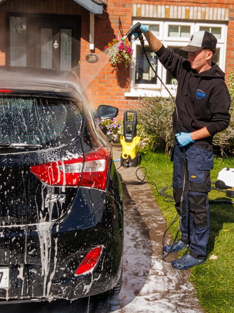 KGS Valeting pressure-washing a car on a customer's driveway