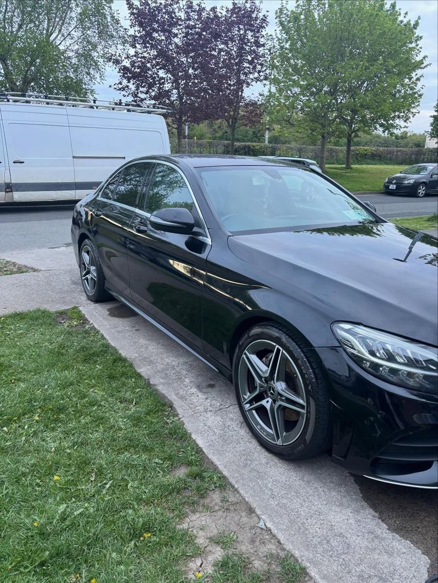 Black Mercedes saloon gleaming after a wash