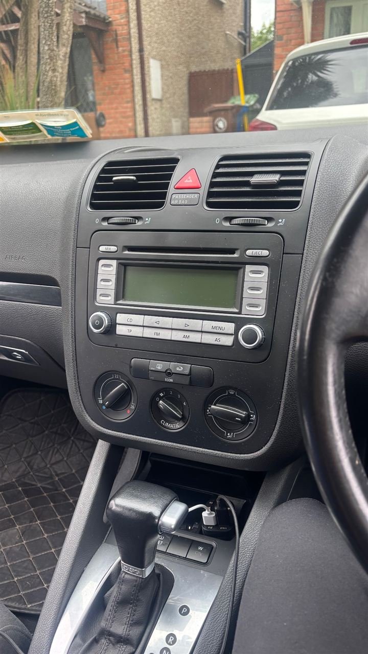 VW Golf dashboard with the original factory radio, before the CarPlay install